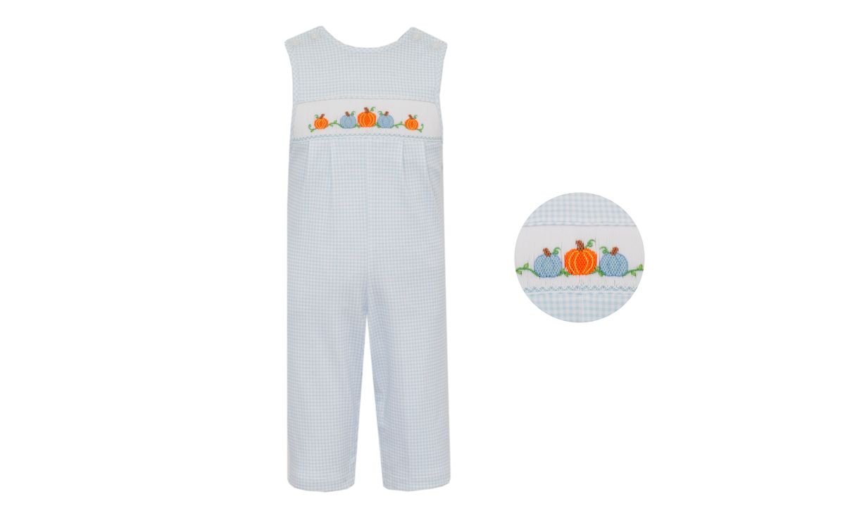 Children's overalls with pumpkin design on a light blue checkered background