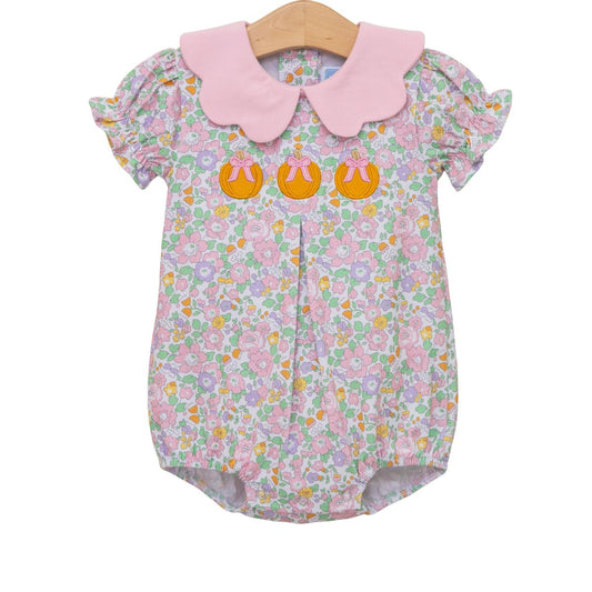 Baby romper with floral pattern with pumpkins and pink collar on a white background