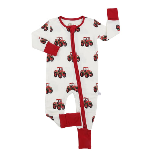 A baby long-sleeve footless sleeper with a red zipper, featuring an all-over print of red tractors on a white background, with solid red cuffs and leg cuffs.