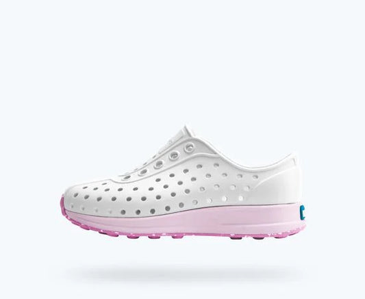 White shoe with pink sole on a white background