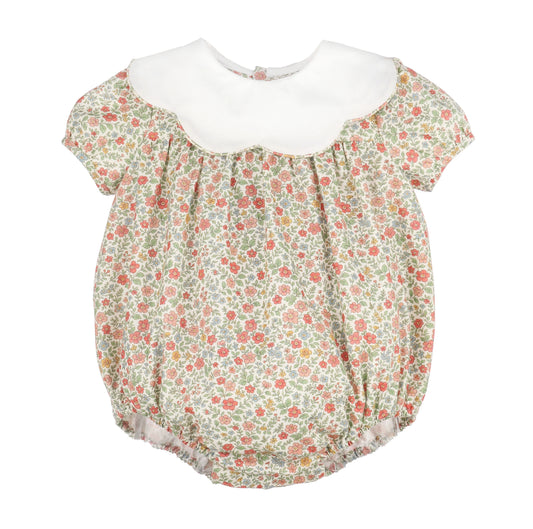 A baby girl's short-sleeve bubble romper with a white scalloped collar and a green, pink, and beige floral print, shown against a plain white background.