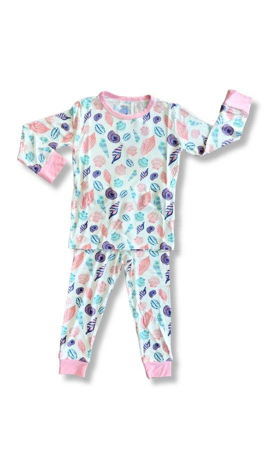 Children's pajama set with a colorful shell pattern on a white background