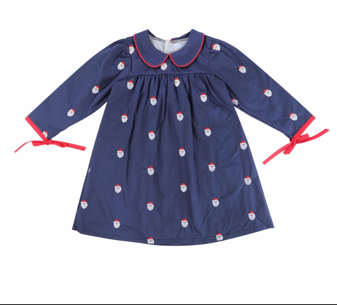 A navy blue long-sleeve dress with a Peter Pan collar, decorated with a repeating pattern of Santa Claus faces, and finished with red trim and red ribbon ties at the cuffs.
