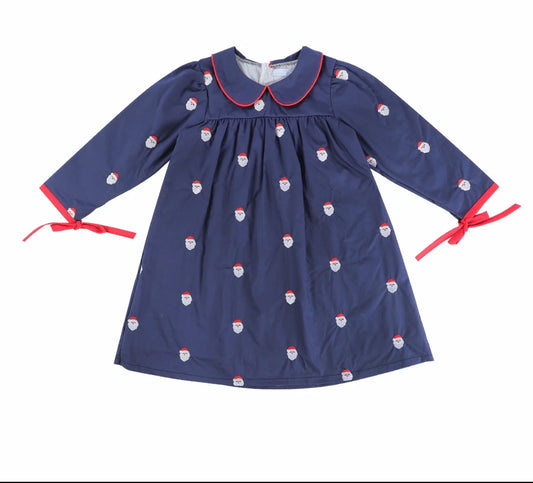 A navy blue long-sleeve dress with a Peter Pan collar, decorated with a repeating pattern of Santa Claus faces, and finished with red trim and red ribbon ties at the cuffs.