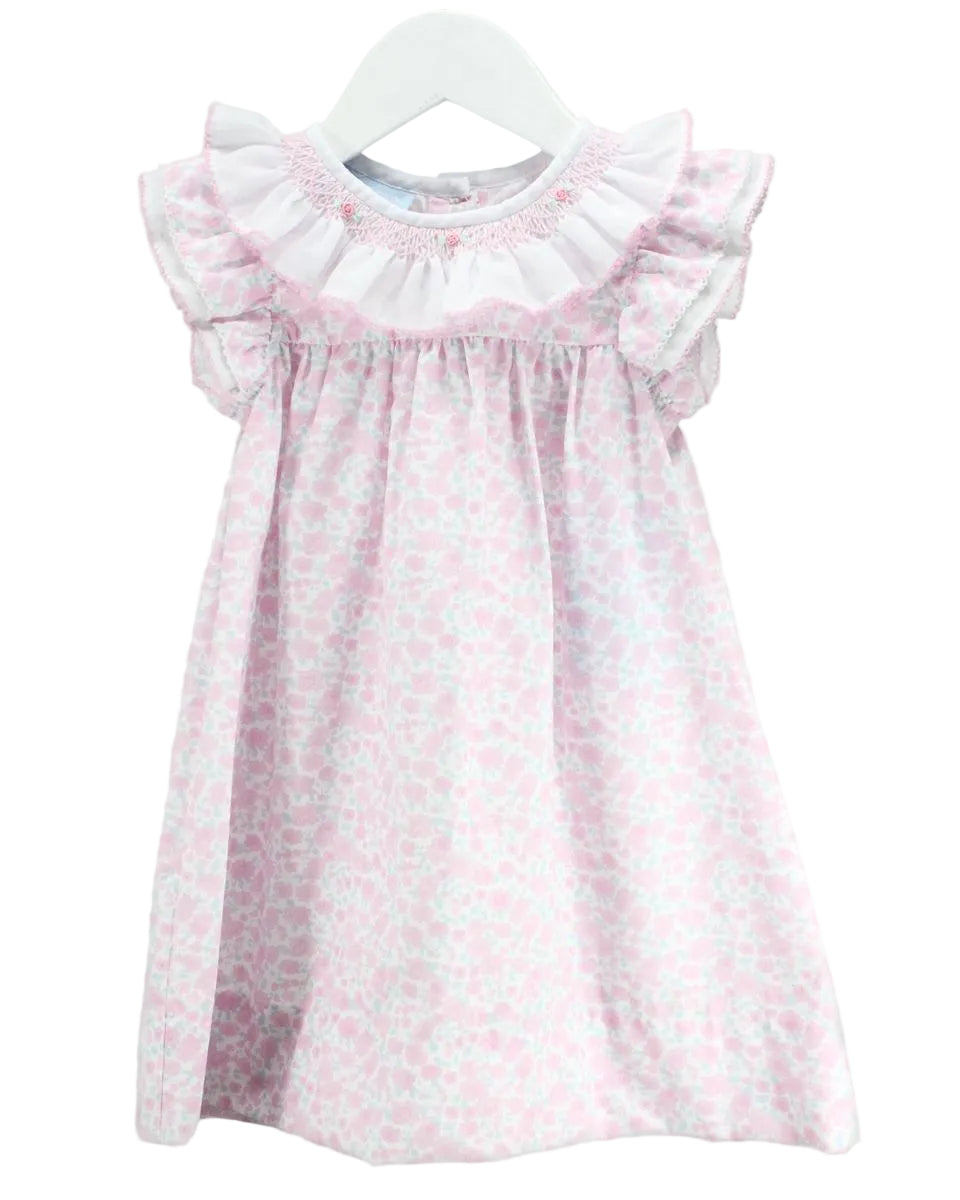 Pink floral smocked dress with ruffle collar and sleeves.
