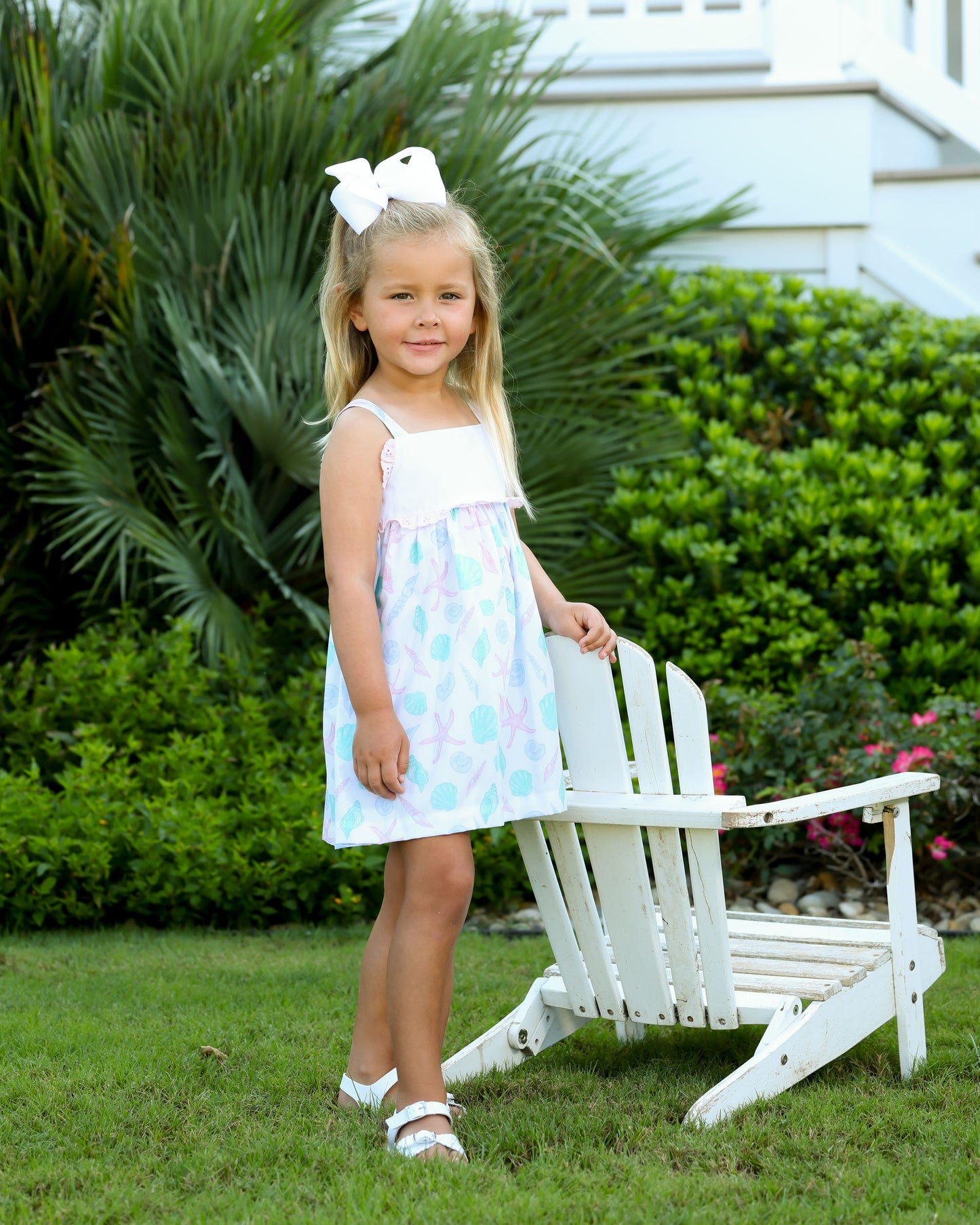 White dress with green/pink seashell design with white top and pink eyelet design in middle 
