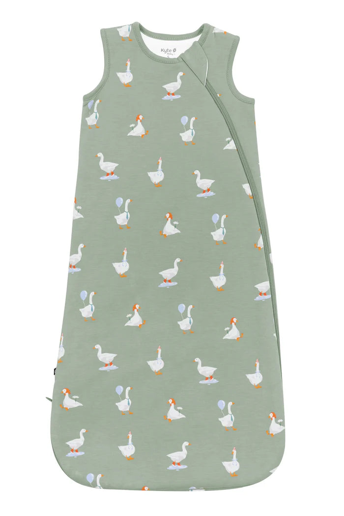 Green sleep bag with white goose pattern.