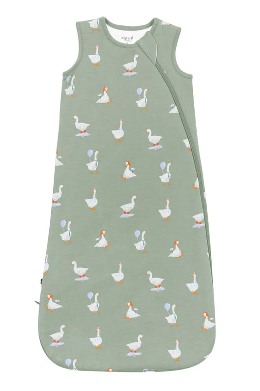Green sleep bag with white goose pattern.