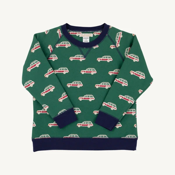 A green long-sleeve crewneck sweatshirt with an allover pattern of red and cream campervans, featuring solid navy blue ribbed collar, cuffs, and hem.