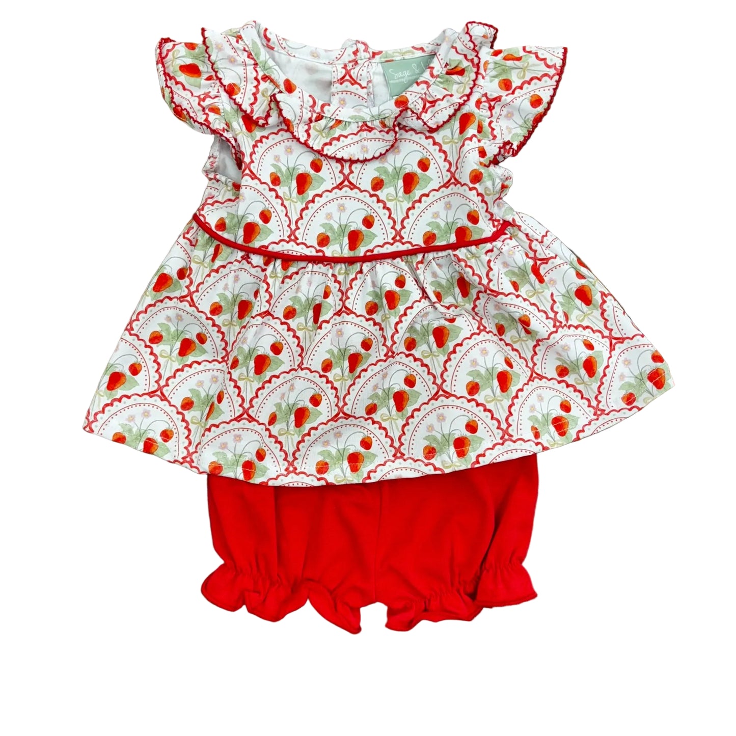 Ruffle sleeve and collar on a strawberry print top and red bloomers.