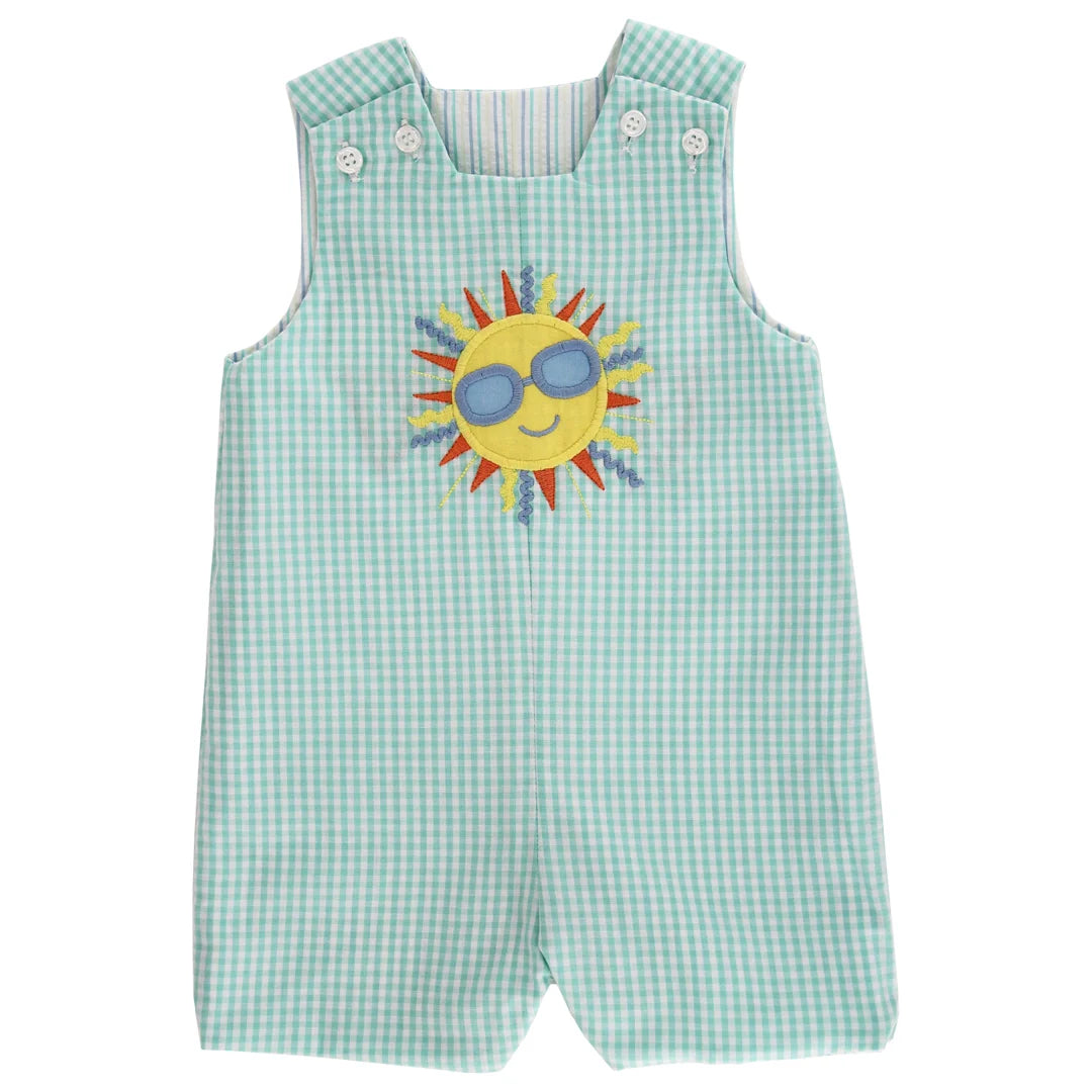 Green checkered romper with a sun design