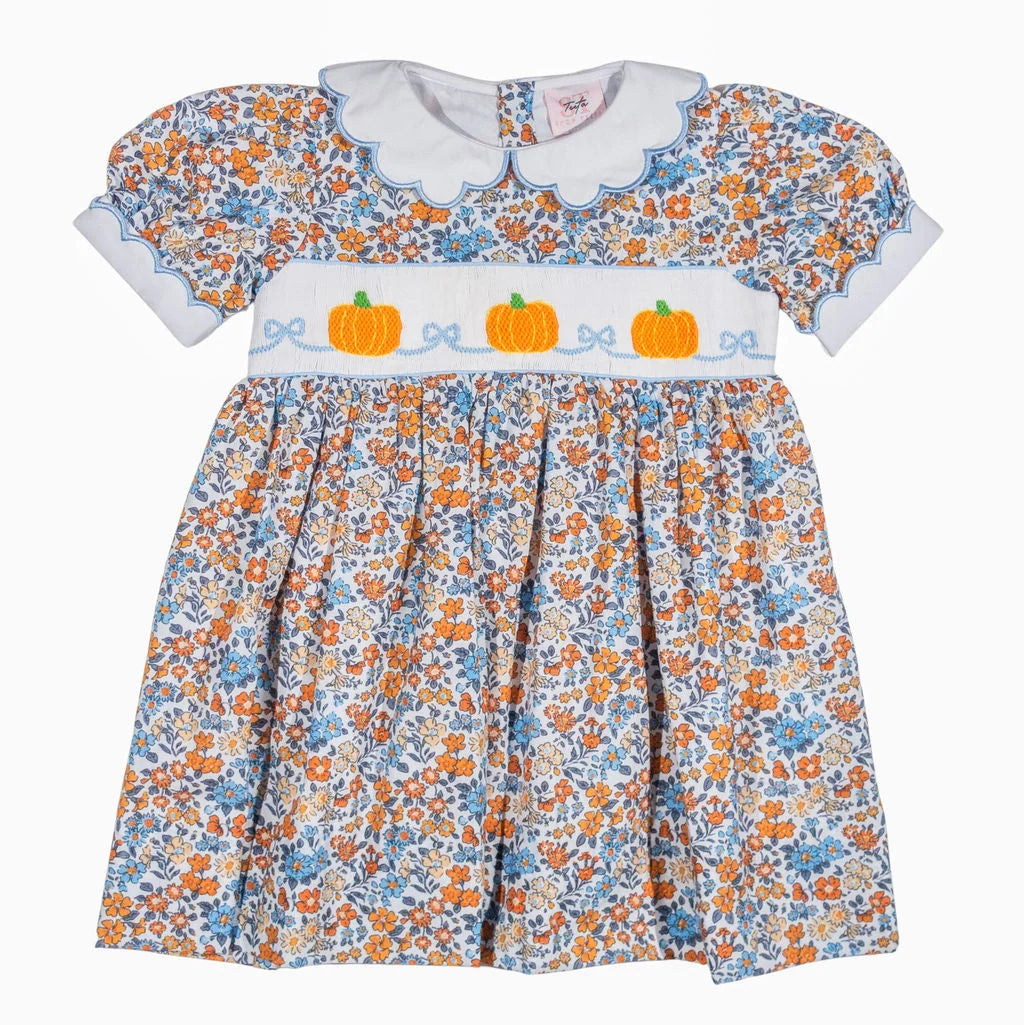Children's dress with floral pattern and pumpkin design on a white background