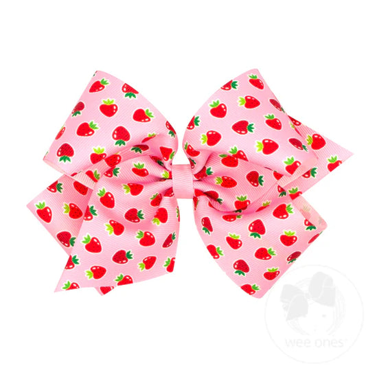 Pink hair bow with strawberry print.