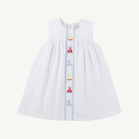 white sleeveless dress with colorful sailboats down the middle 