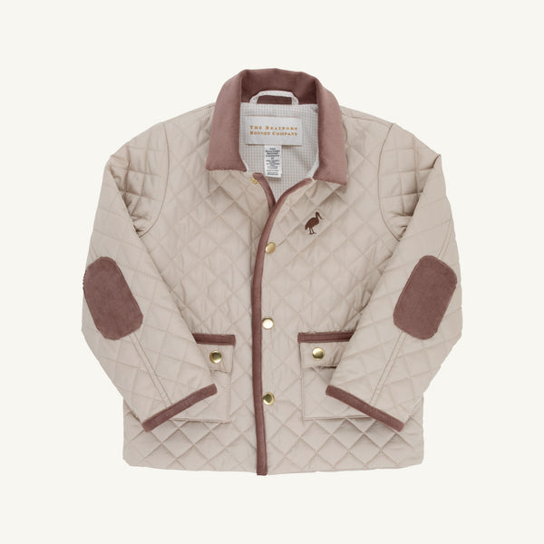 A quilted jacket in a light beige color with brown trim, brown elbow patches, and gold-tone buttons, shown flat on a light cream background.