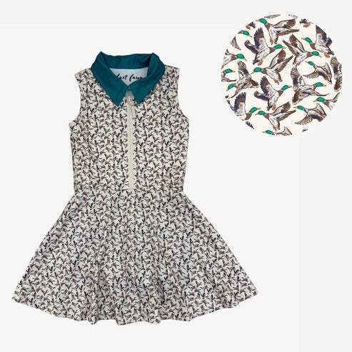 Dress with overall mallard print on cream background with navy collar.