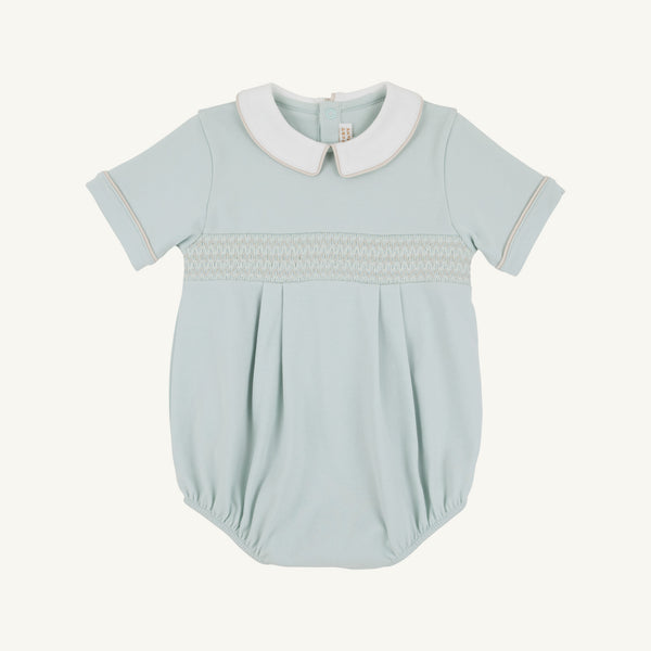 Light blue baby romper with tan smocking with white collar on a white background