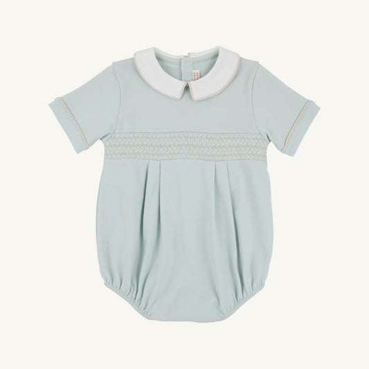 Light blue baby romper with tan smocking with white collar on a white background