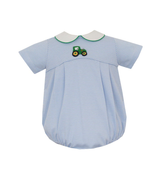 A baby romper in light blue and white stripes, featuring a white Peter Pan collar with green trim and an embroidered green tractor motif on the chest.