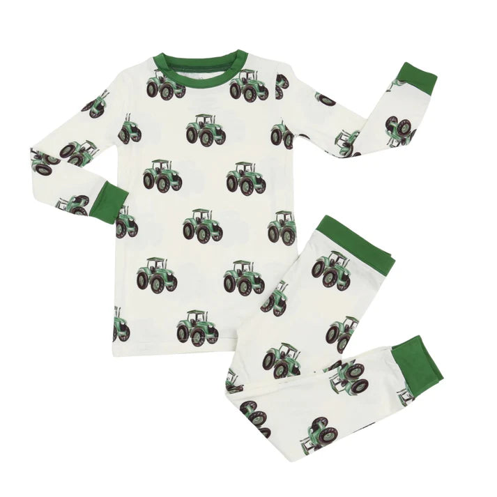 Two piece pajama set with green trim and green tractor design.