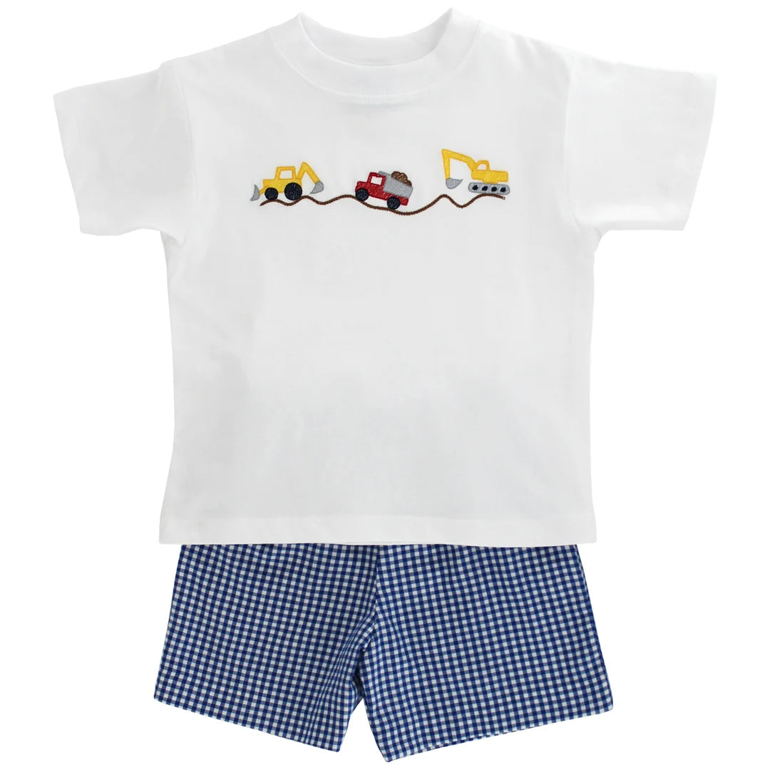 White t-shirt with construction vehicle design and blue checkered shorts 