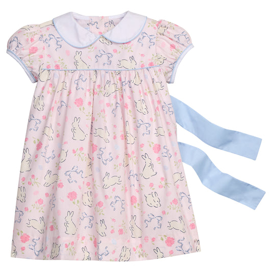 Children's dress with bunny and flower pattern on a pink background