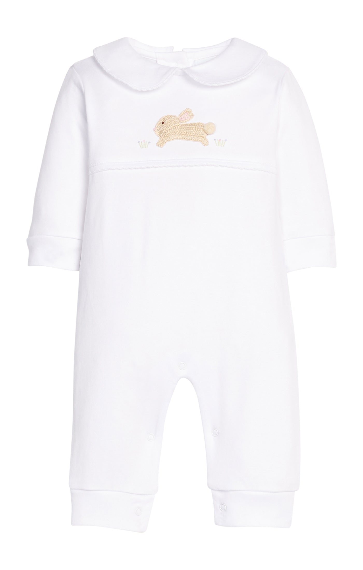 White baby onesie with a small embroidered design on a white background