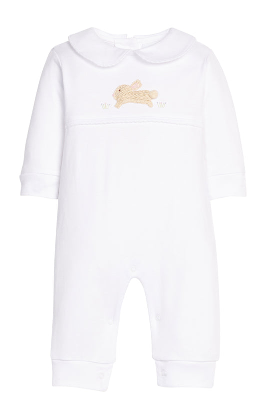White baby onesie with a small embroidered design on a white background