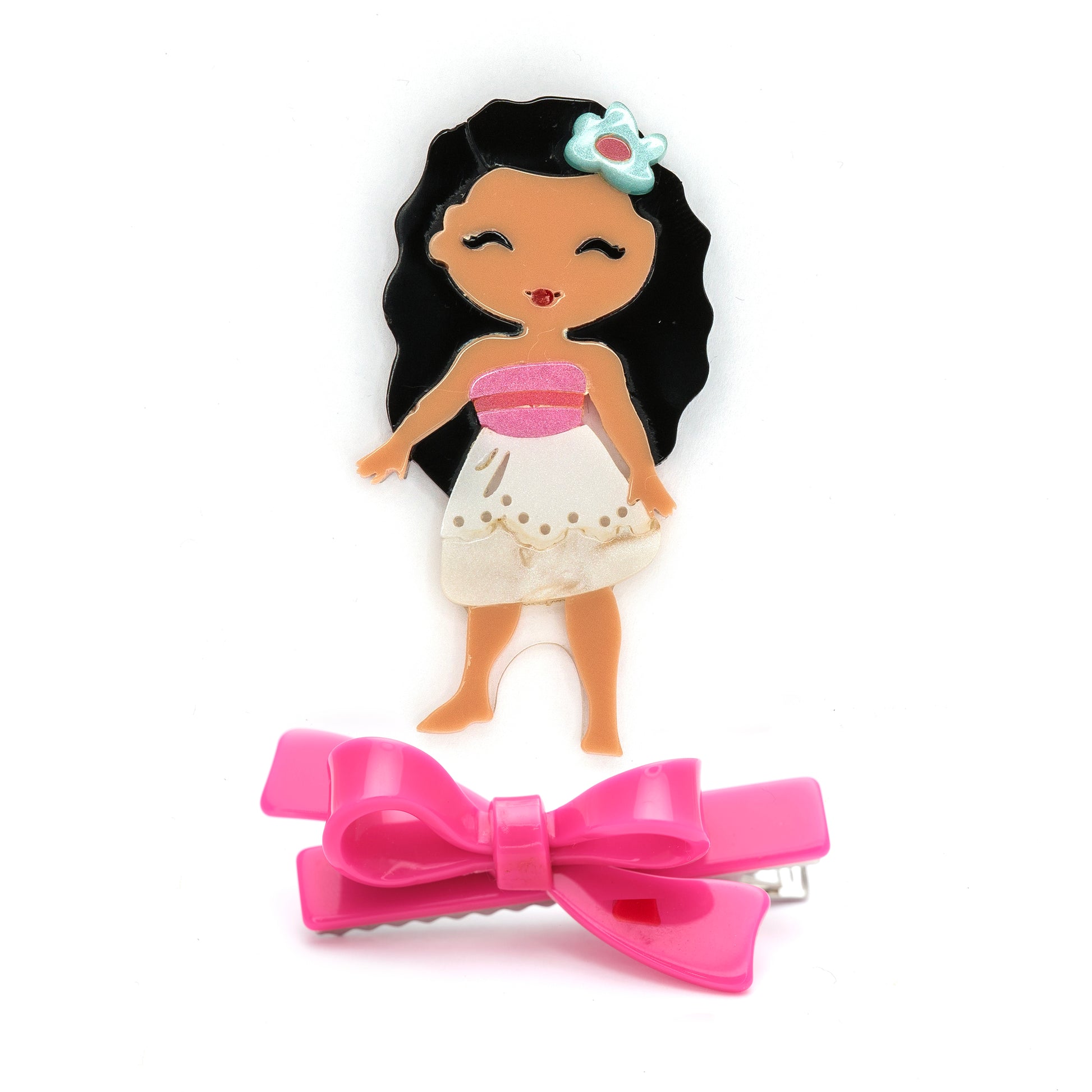 Hair clip with a pink bow and a small figurine of a girl with black hair and a white dress 