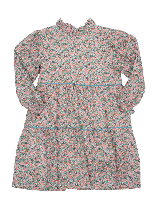 A long-sleeve tiered dress with a small floral pattern in muted pink, beige, and brown tones with a ruffle collar and blue trim.