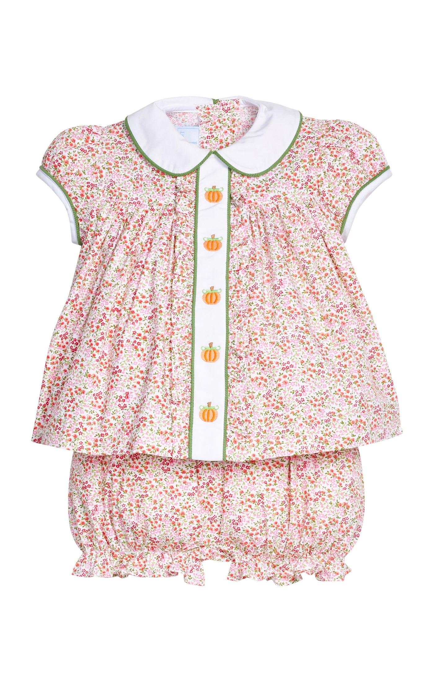 A baby girl's two-piece outfit featuring a short-sleeve blouse and matching bloomers. The outfit has a light pink and white floral print with green trim, a white Peter Pan collar, and a vertical white placket decorated with small orange pumpkin buttons.