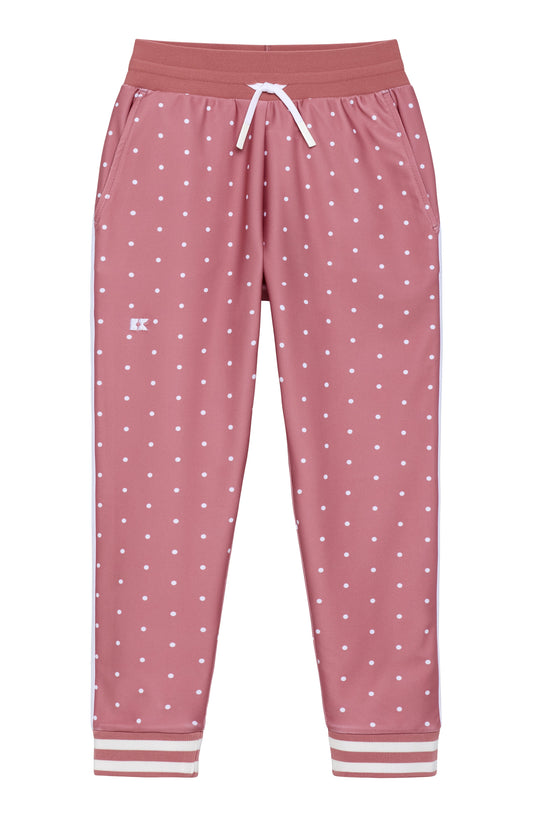 Pink jogger pants with a white polka dot pattern, featuring an elastic waistband with a white drawstring and striped cuffs.