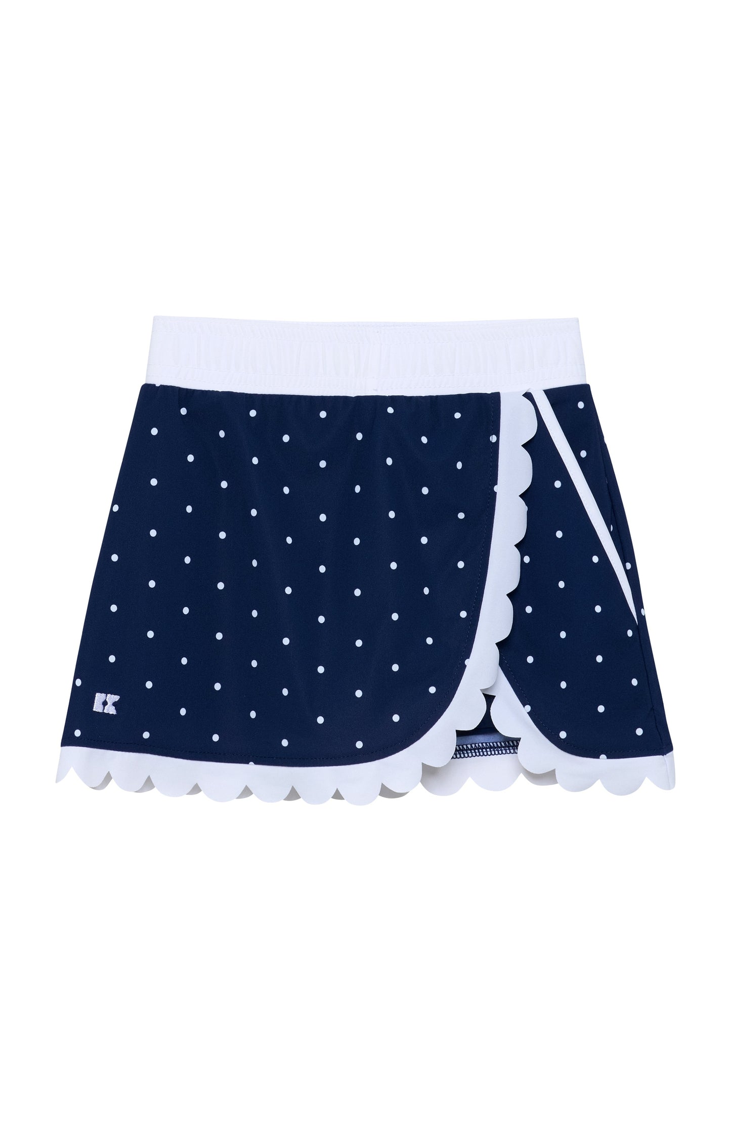 A navy blue wrap-style skirt with white polka dots, a white waistband, and white scalloped trim along the front edges.
