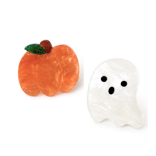 Two Halloween-themed resin charms on a white background: an orange pumpkin with a green glittery leaf and brown stem, and a white ghost with black eyes and mouth.