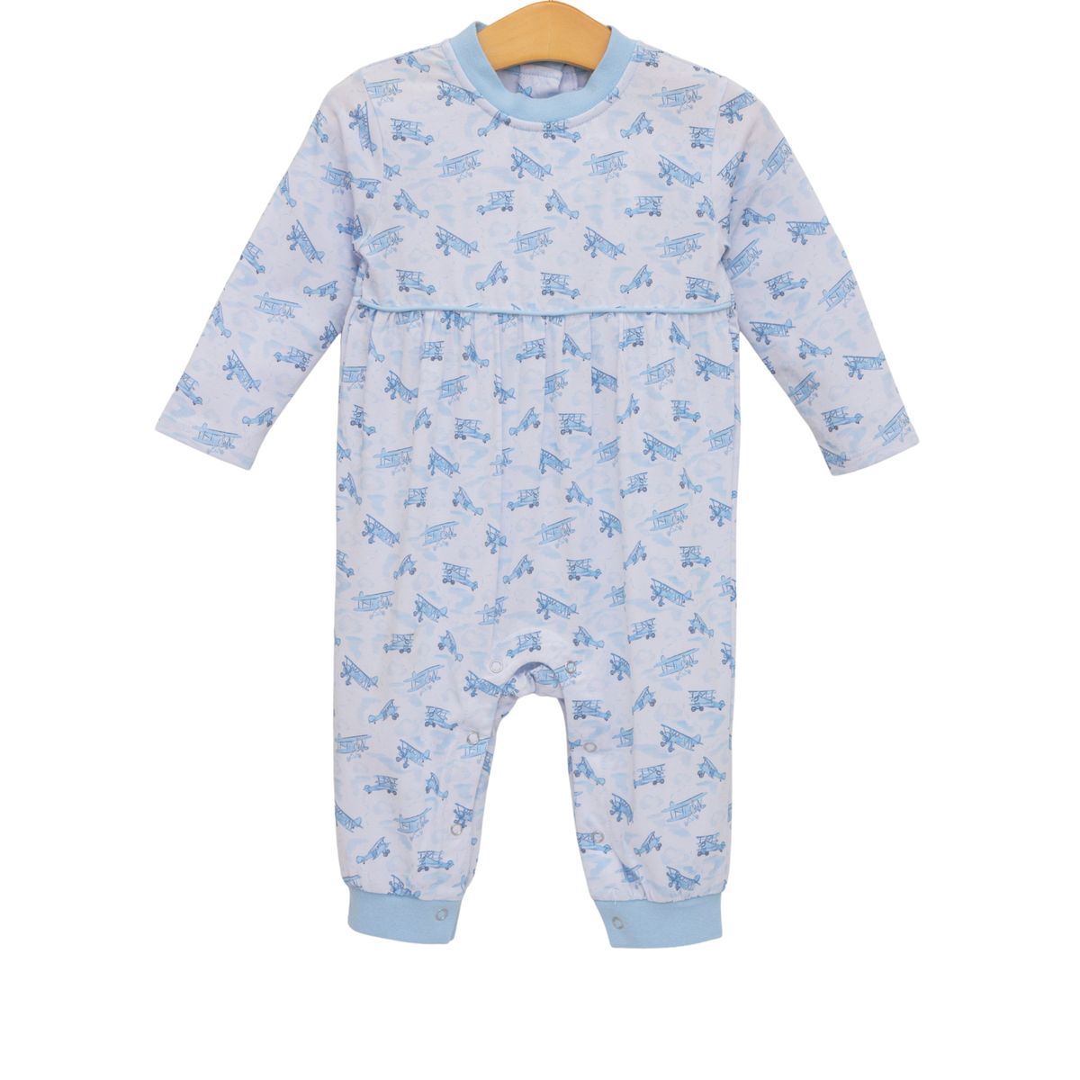 Baby onesie with blue airplane pattern on a white background