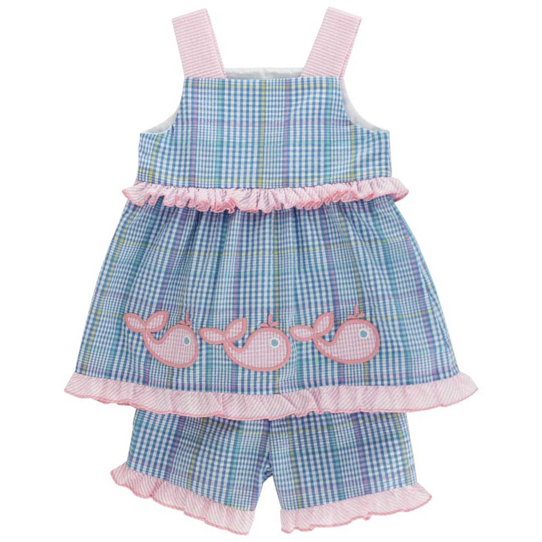 Children's blue checkered dress with pink whale appliqués on a white background