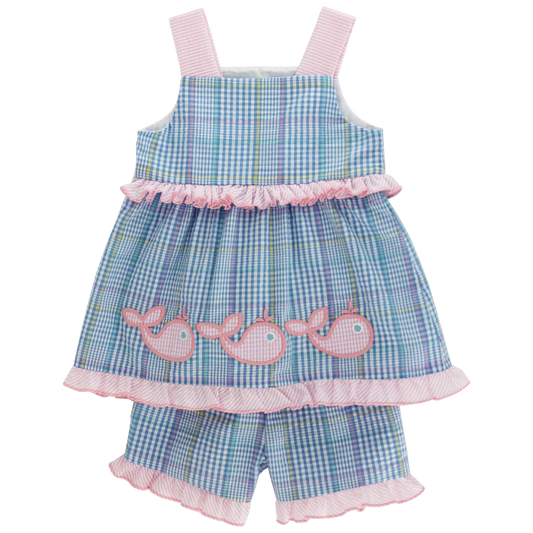 Children's blue checkered dress with pink whale appliqués on a white background
